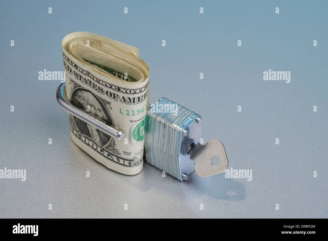 Dollar bills in an open padlock Stock Photo Alamy