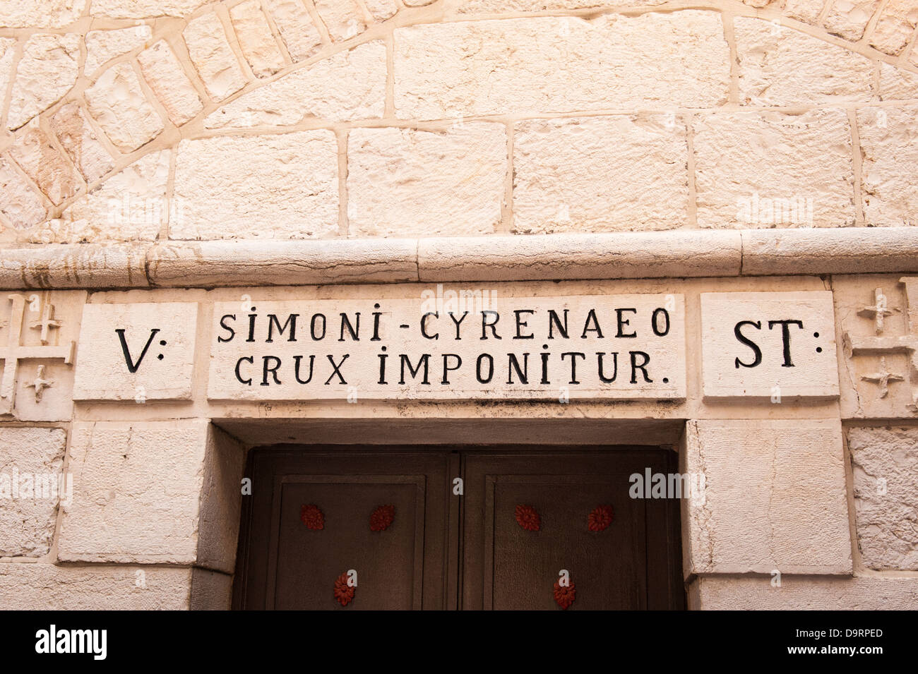 Israel Jerusalem Old City 5 5th Station of the Cross Simon Cyrene told by Romans to help Jesus carry cross after fall Stock Photo