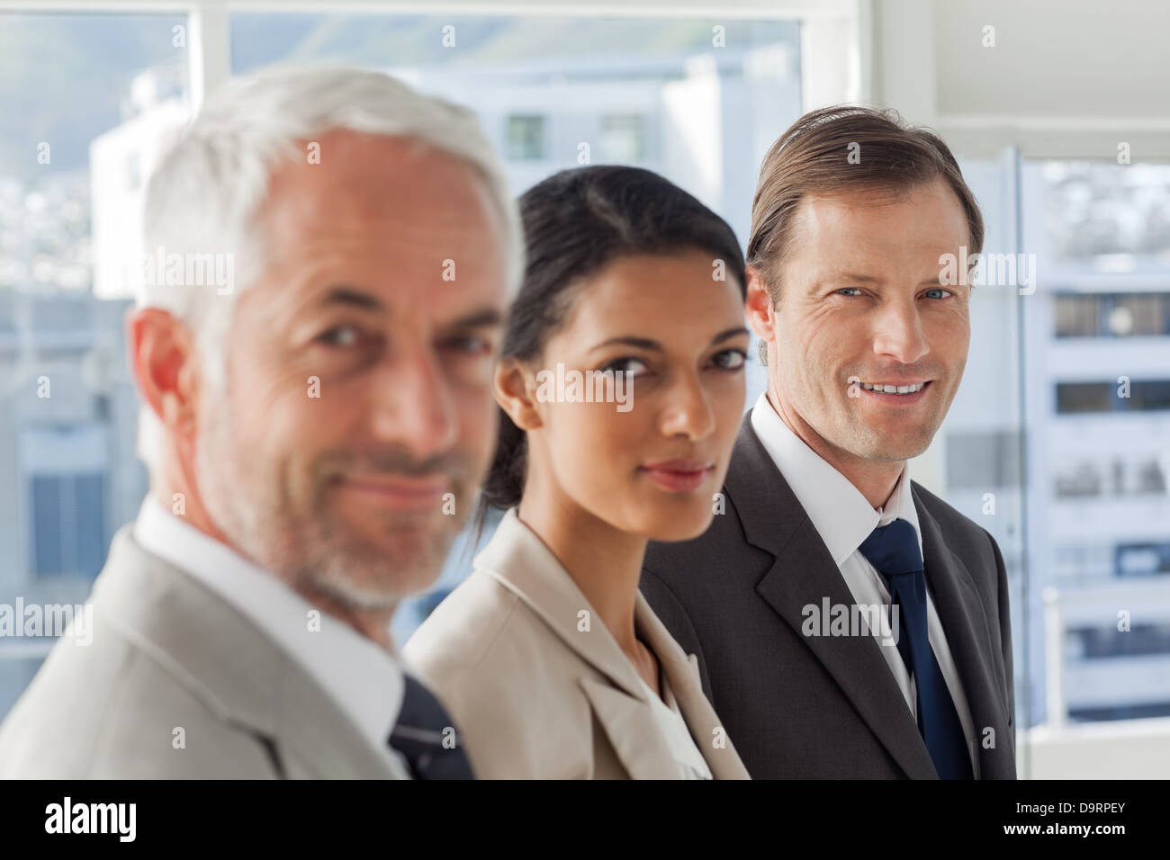 Serious business people looking in the same way Stock Photo