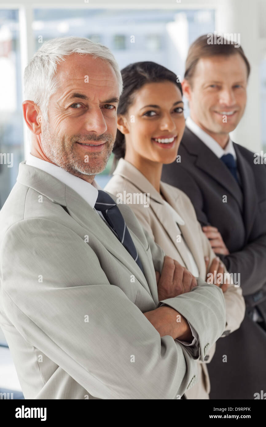 Cheerful business people looking in the same way Stock Photo