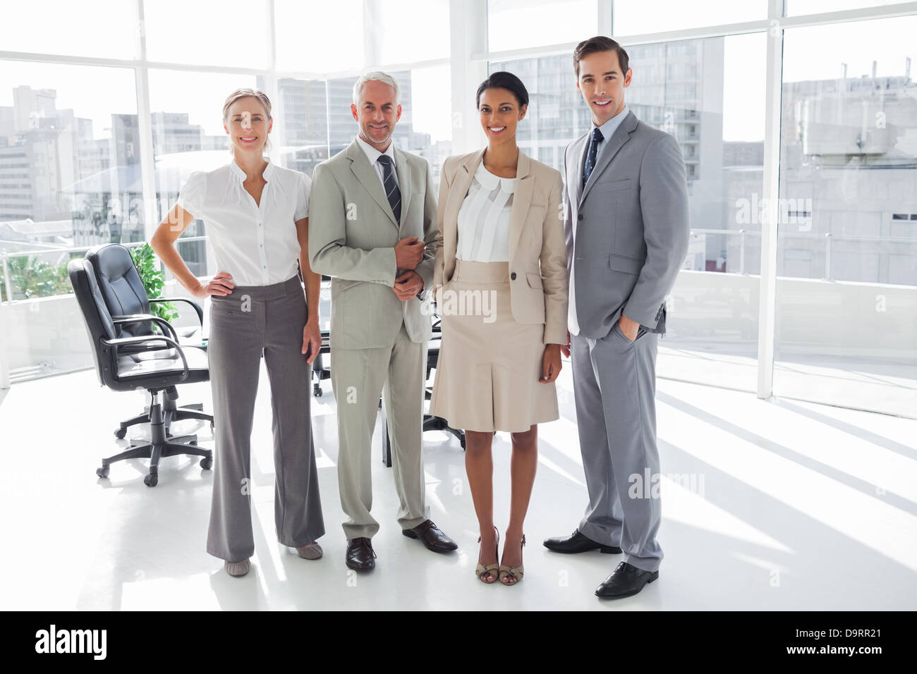 Smiling business people standing in line Stock Photo - Alamy