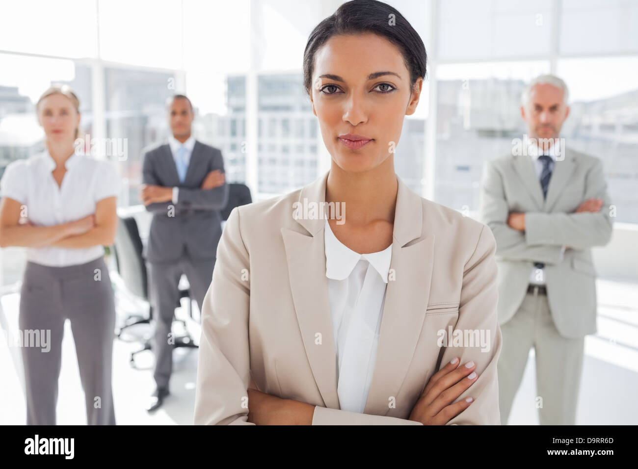 Attractive serious businesswoman with arms crossed Stock Photo - Alamy