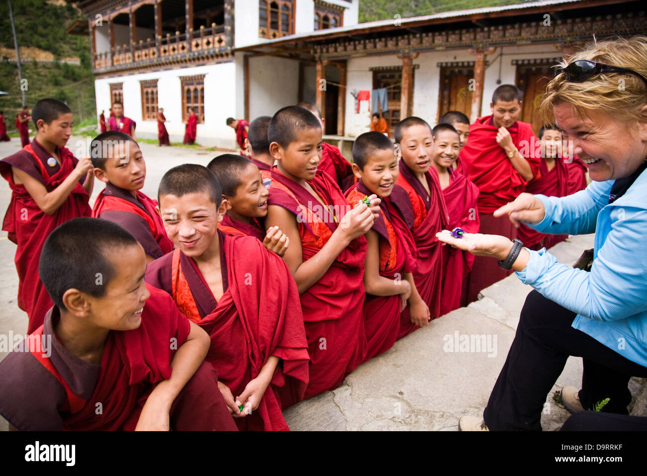 Young monks are delighted by toy gifts from a western visitor at Lhakhang Kharpo (the white chapel) , Haa Valley, Bhutan, Asia. Stock Photo
