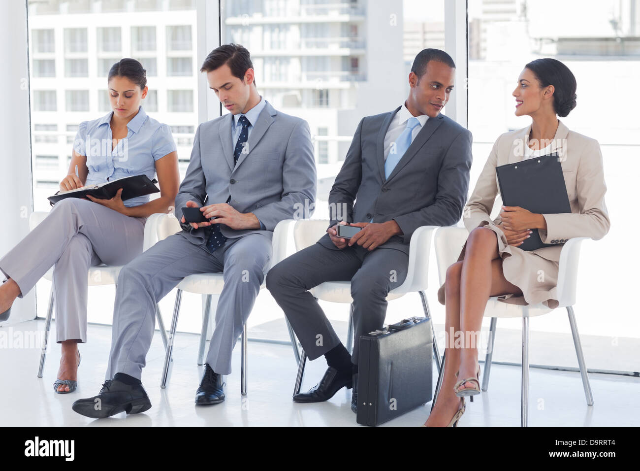 Business people sitting together Stock Photo - Alamy