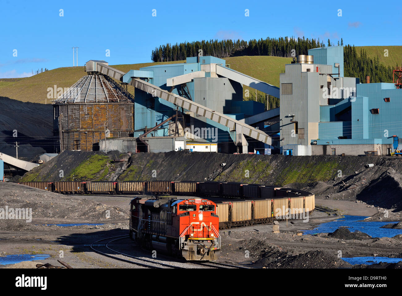 An image of a C.N. freight train being loaded with coal at a processing plant in Western Alberta, Canada. Stock Photo