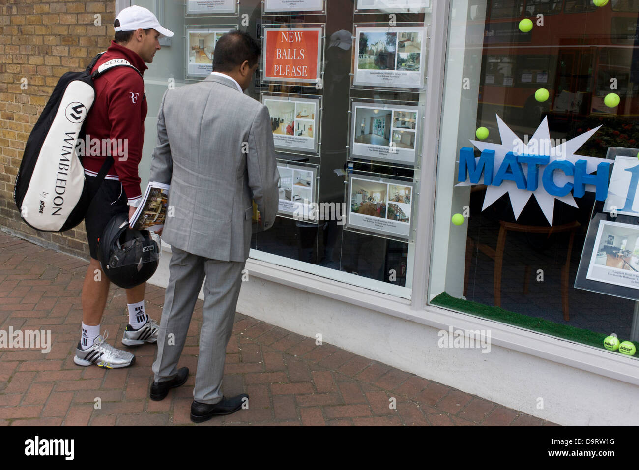 On day 2 of the annual lawn tennis championships, an unknown tennis player looks at property prices in the window of an estate agent in the south London suburb. The Wimbledon Championships, the oldest tennis tournament in the world, have been held at the nearby All England Club since 1877. Stock Photo