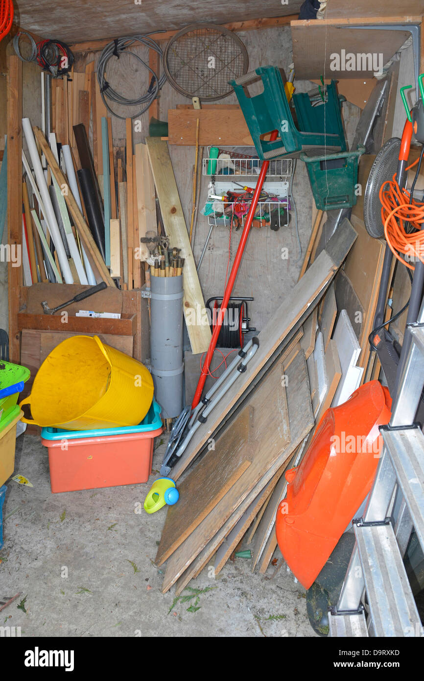 Untidy cluttered interior of wooden garden tool shed Essex England UK Stock Photo