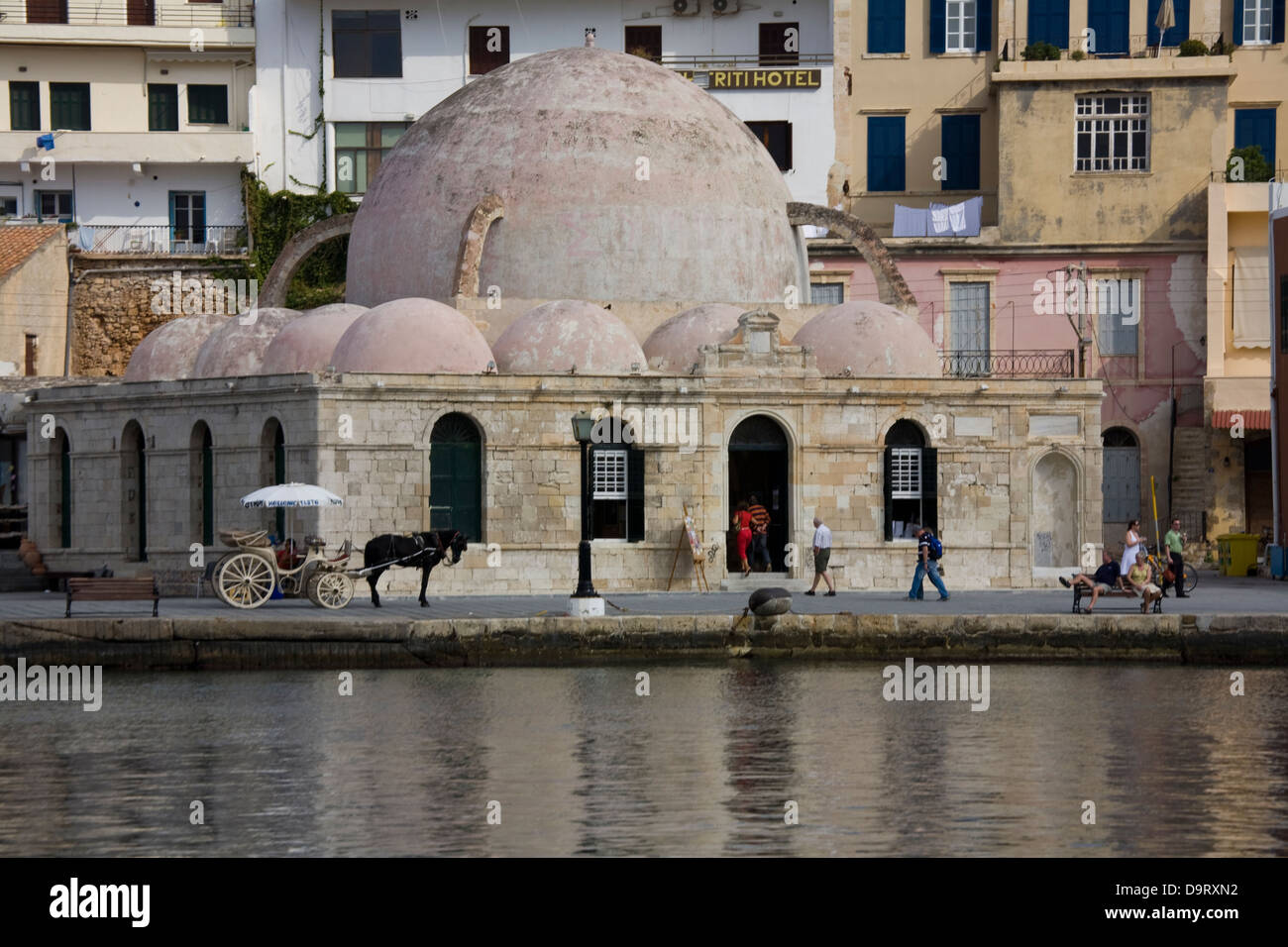 An Ottoman-era mosque now serves as a visitor center in the old Venetian Harbor district of Chania, Crete, Greece. Stock Photo