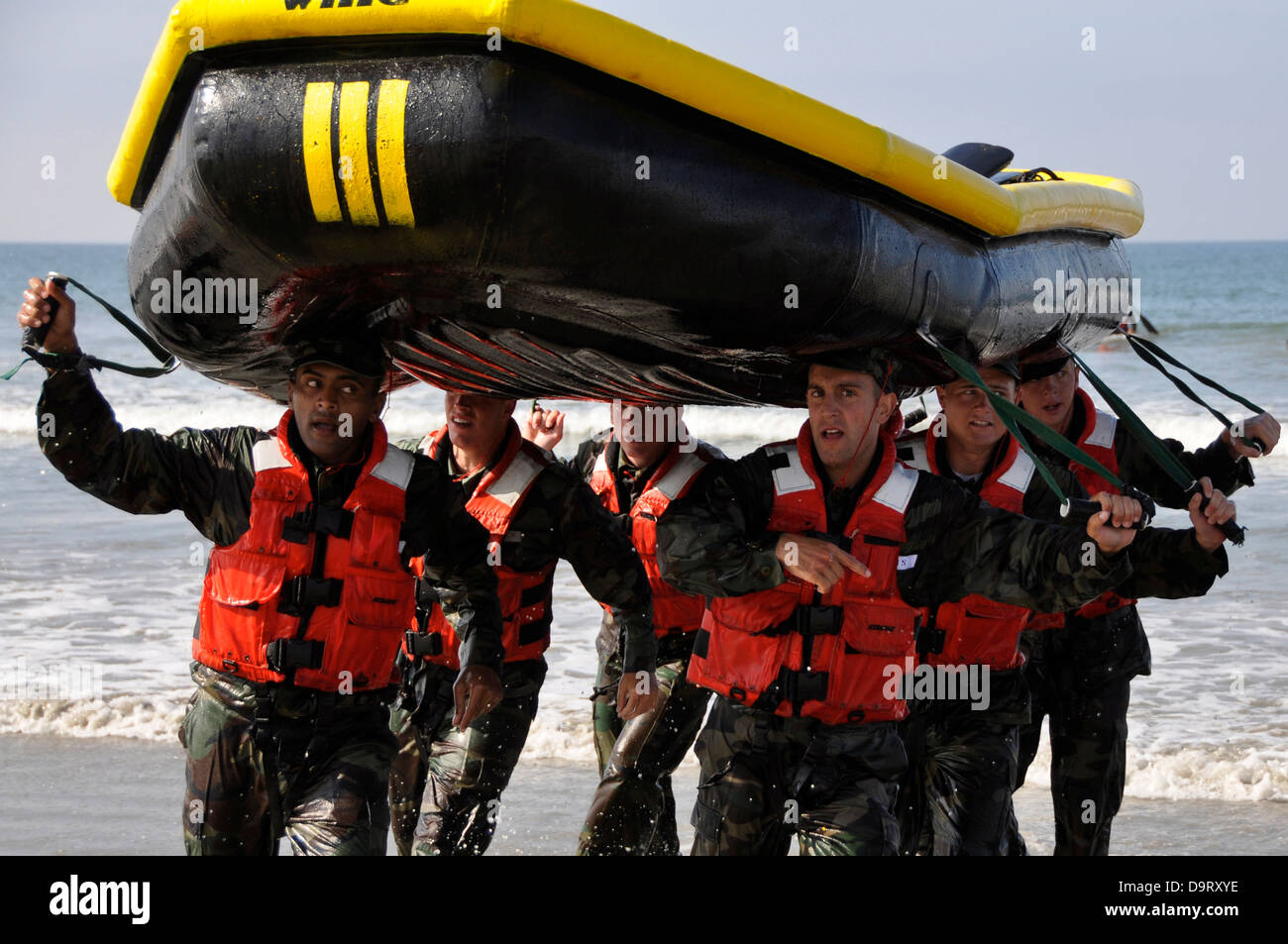 Navy SEAL candidates carry a raft during surf passage exercises on the first phase of training at Naval Amphibious Base Coronado Sep. 10, 2009 in San Diego, CA. Stock Photo
