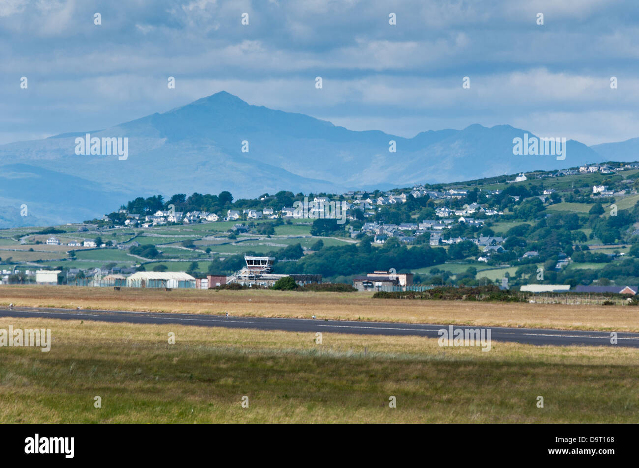Mount Snowdon towers over the airfield buildings at Llanbedr, one of the UK's most picturesque airfields Stock Photo