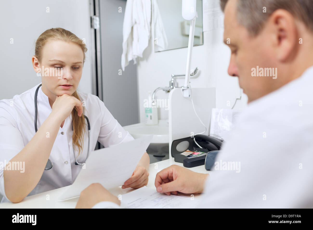 Doctor and nurse discussing analyses Stock Photo