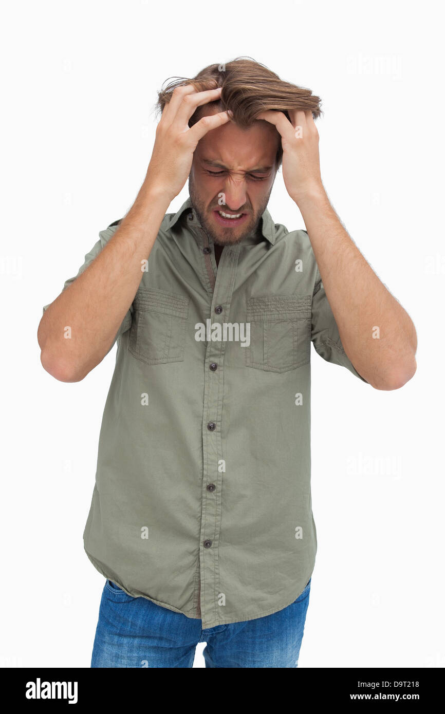 Frustrated Man Pulling His Hair And Looking Down Stock Photo Alamy