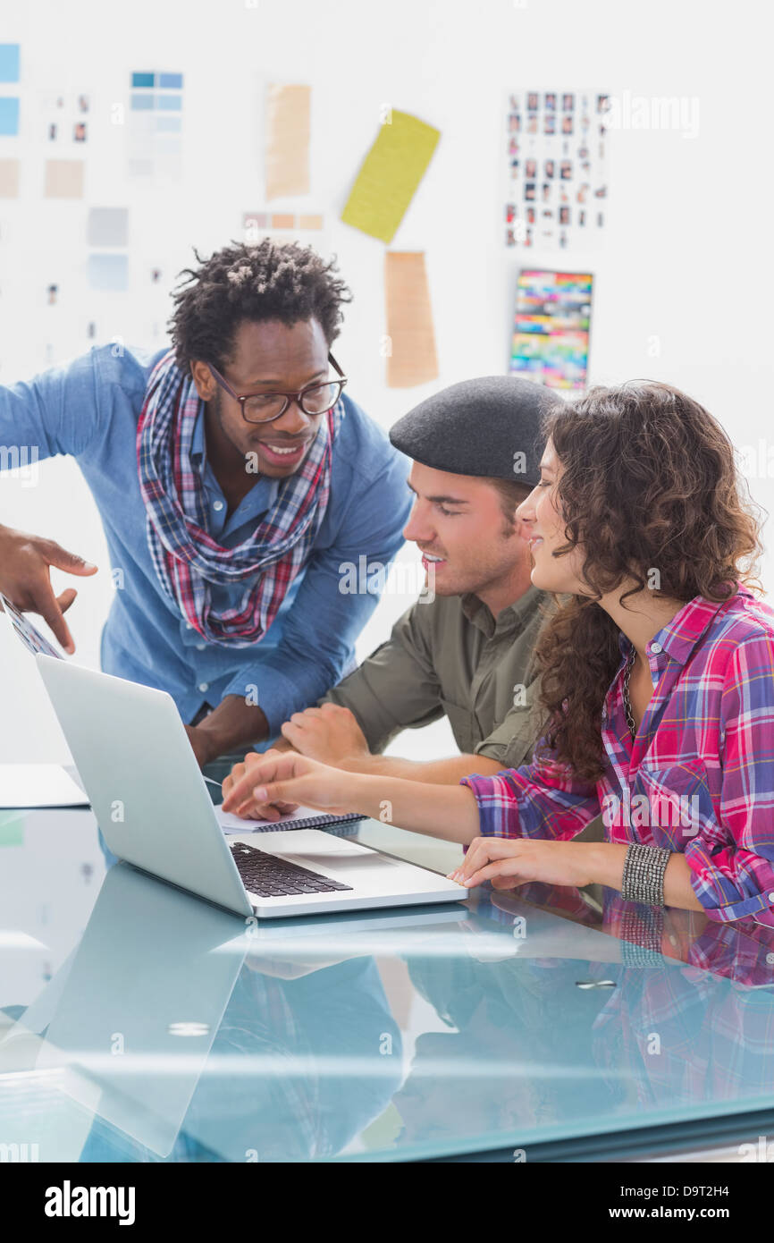 Creative team working together on laptop Stock Photo - Alamy