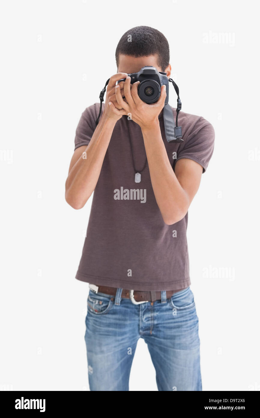 Hip young man pointing his camera at the camera Stock Photo - Alamy