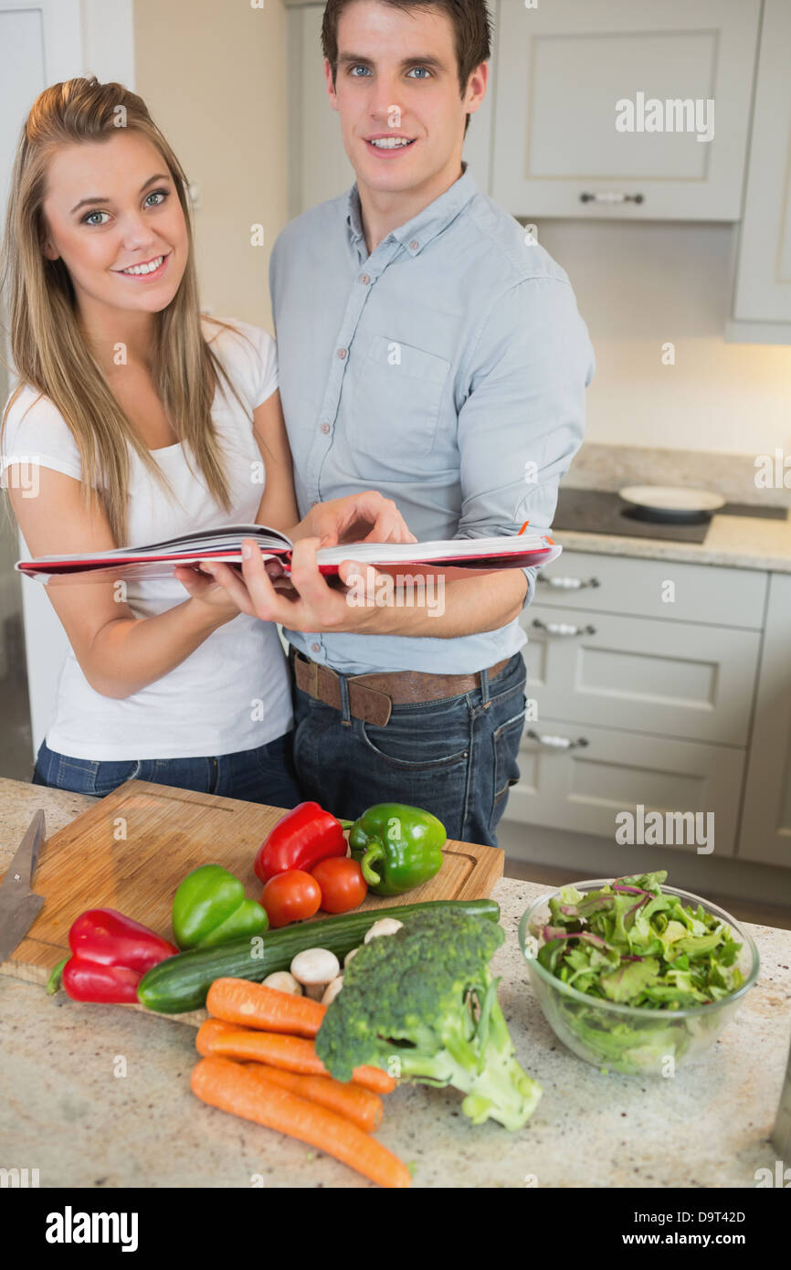 Happy couple with cookery book Stock Photo