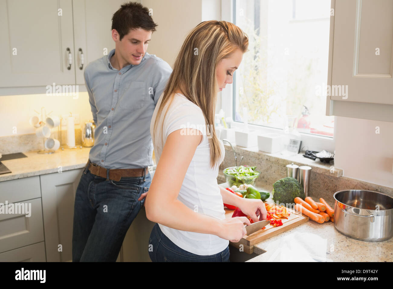 Husband watching wife cutting vegetables hi-res stock photography and  images - Alamy
