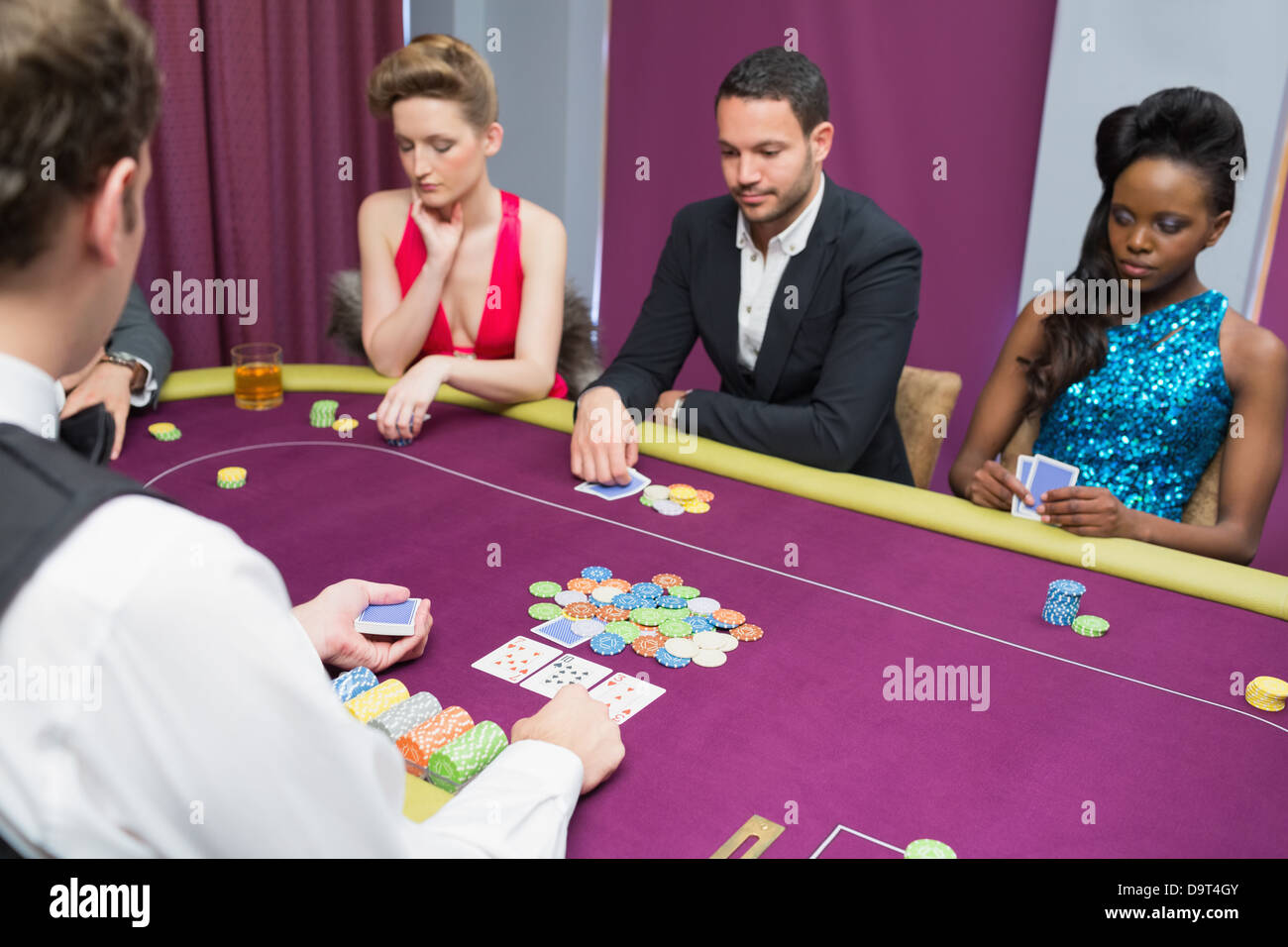 Man and two women playing poker Stock Photo