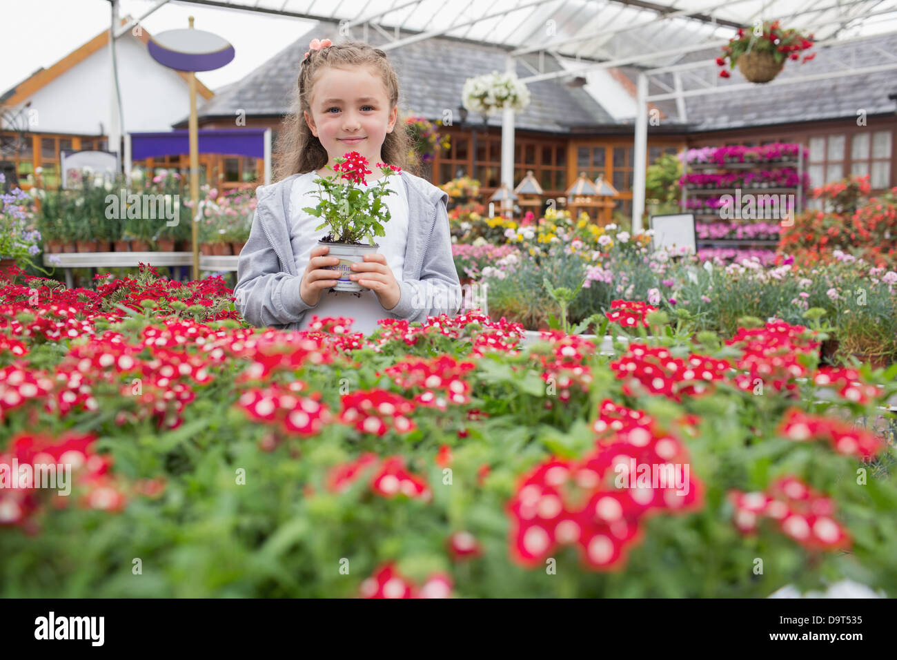 Child holding flower pot Stock Photo - Alamy