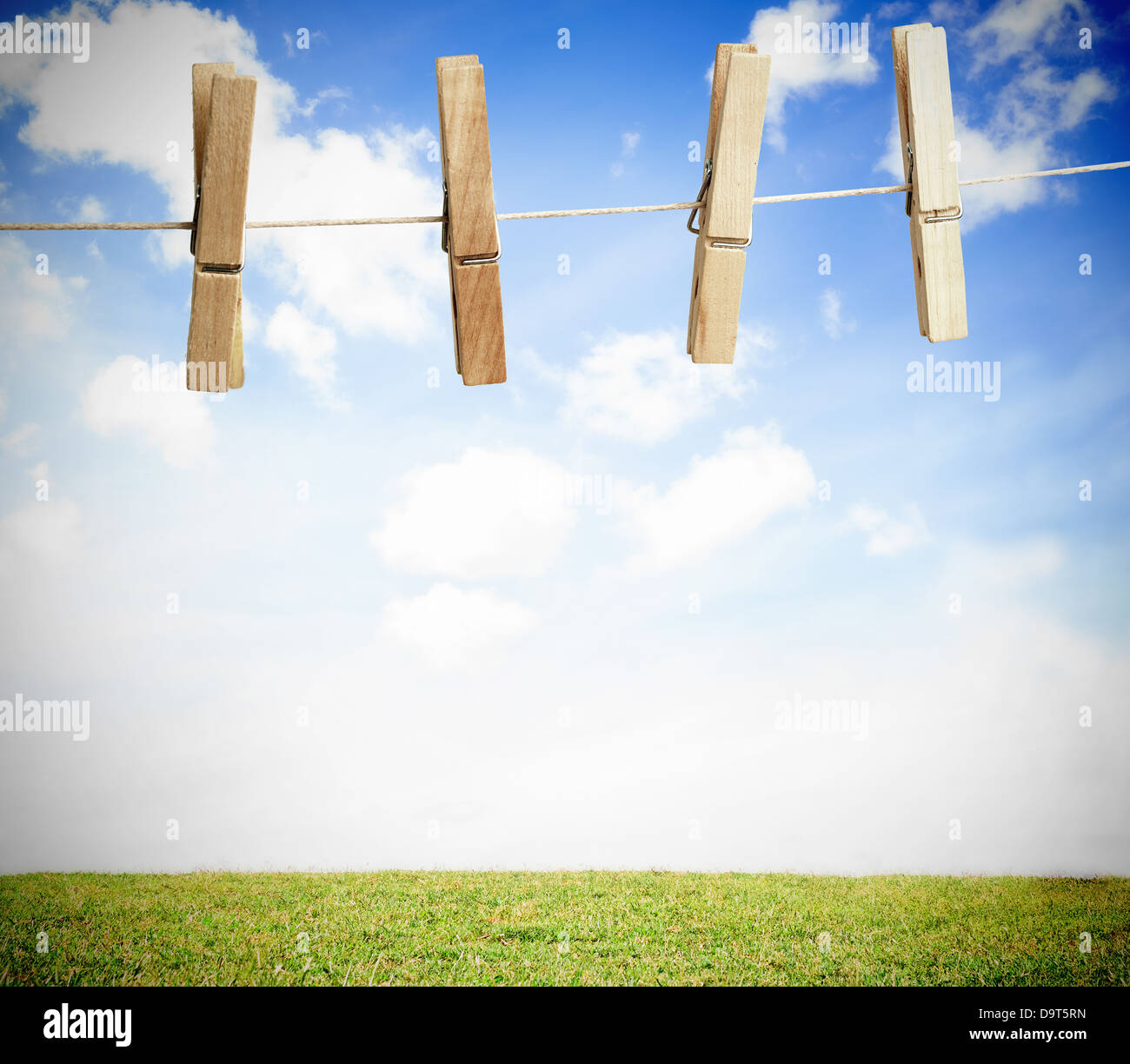 Clothespin on a laundry line outside with bright blue sky Stock Photo