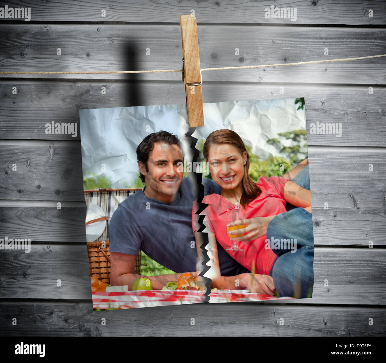 Ripped photo of couple hung with a peg Stock Photo