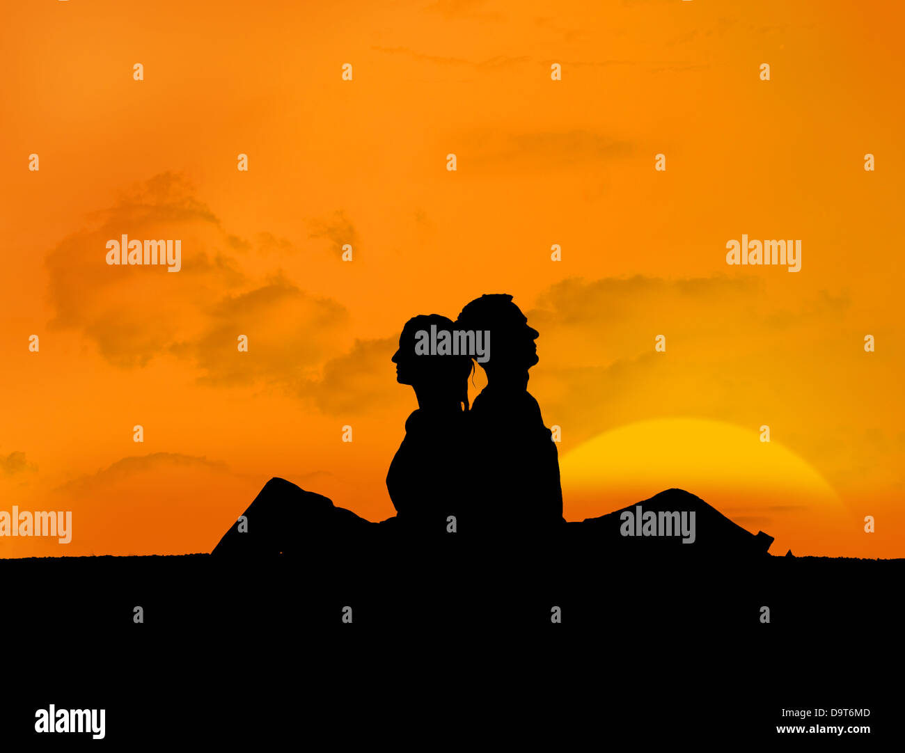 Silhouette of couple relaxing under a sunset Stock Photo - Alamy
