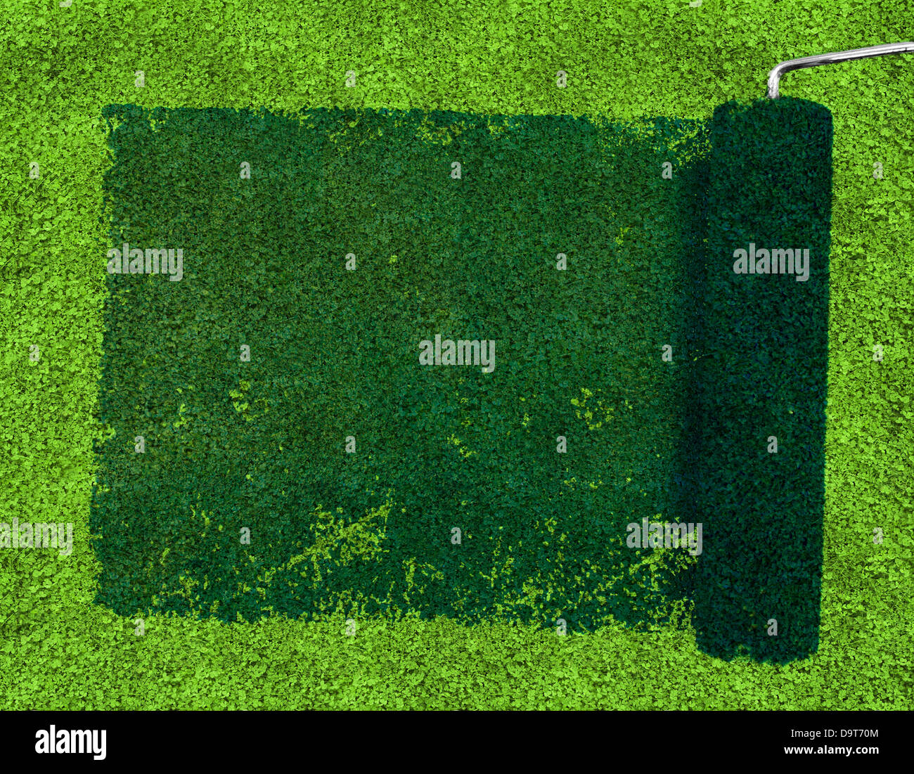 Paint roller over grass Stock Photo