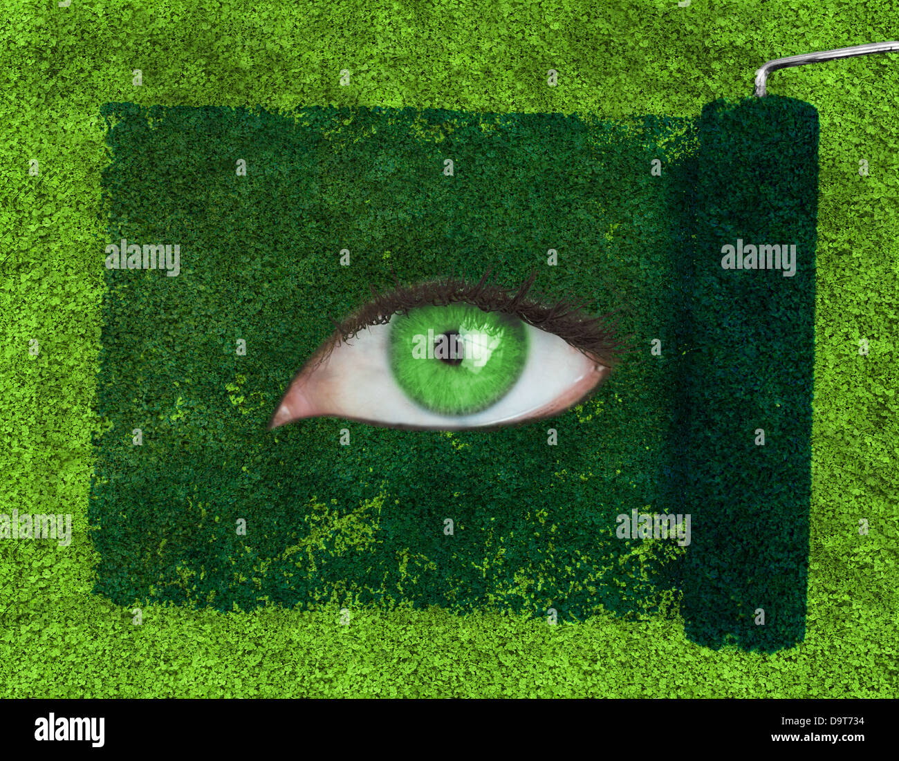 Paint roller revealing a green eye Stock Photo