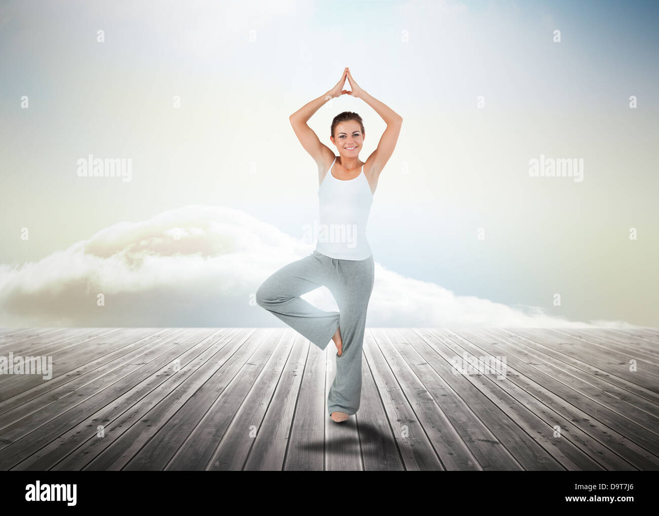 Woman practicing yoga over wooden boards Stock Photo