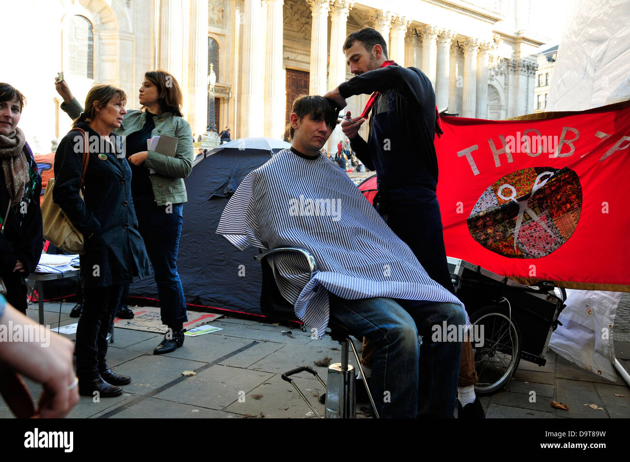A man having a free hair cut, Occupy London camp, UK. Stock Photo