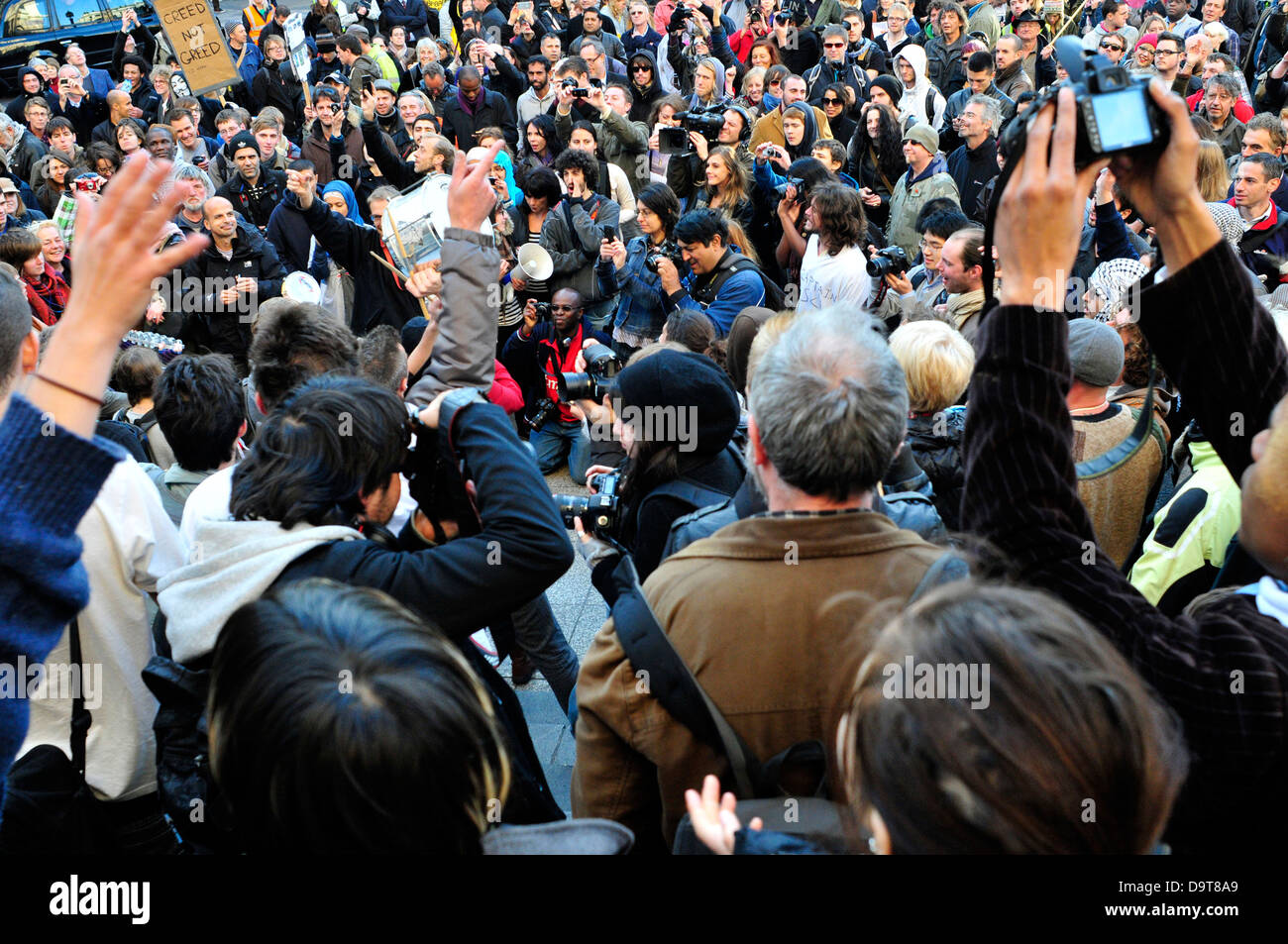 A  crowd listening to a speaker at occupy London camp, St Paul's Church Yard, London, UK. Stock Photo