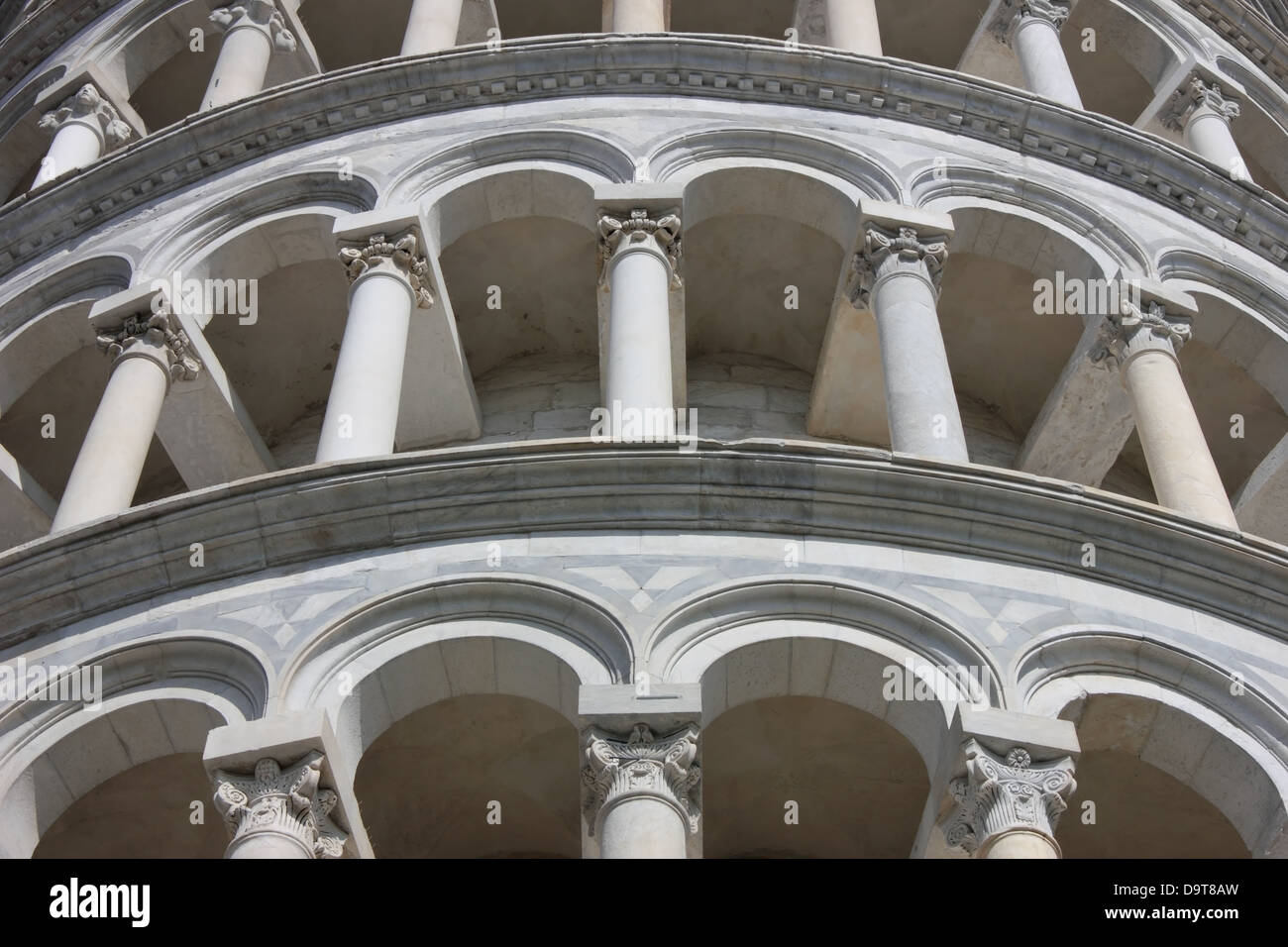 Famous Leaning Tower in Pisa detail of the marble arches on piazza dei Miracoli. Stock Photo