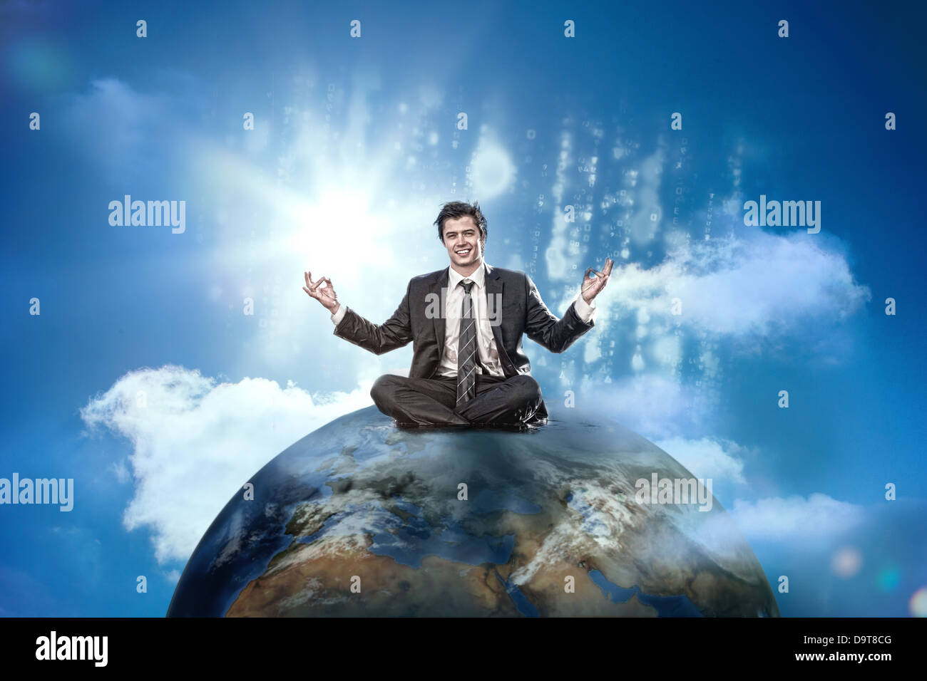 Businessman sitting on top of the world Stock Photo