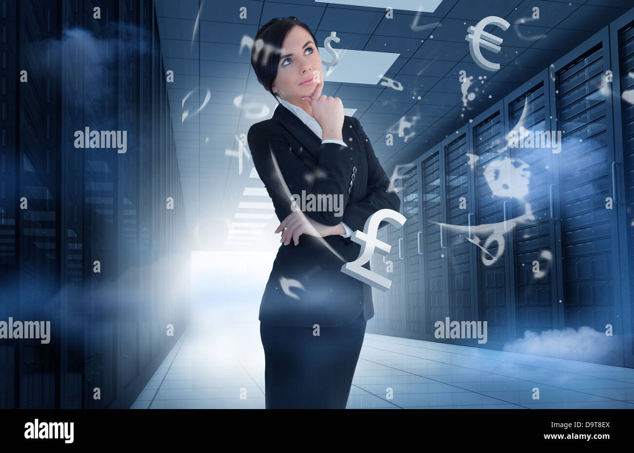 Businesswoman standing in data center with currency graphics Stock Photo
