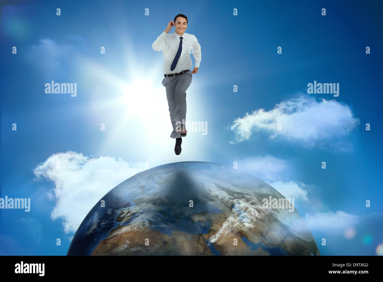 Businessman racing on top of the world Stock Photo