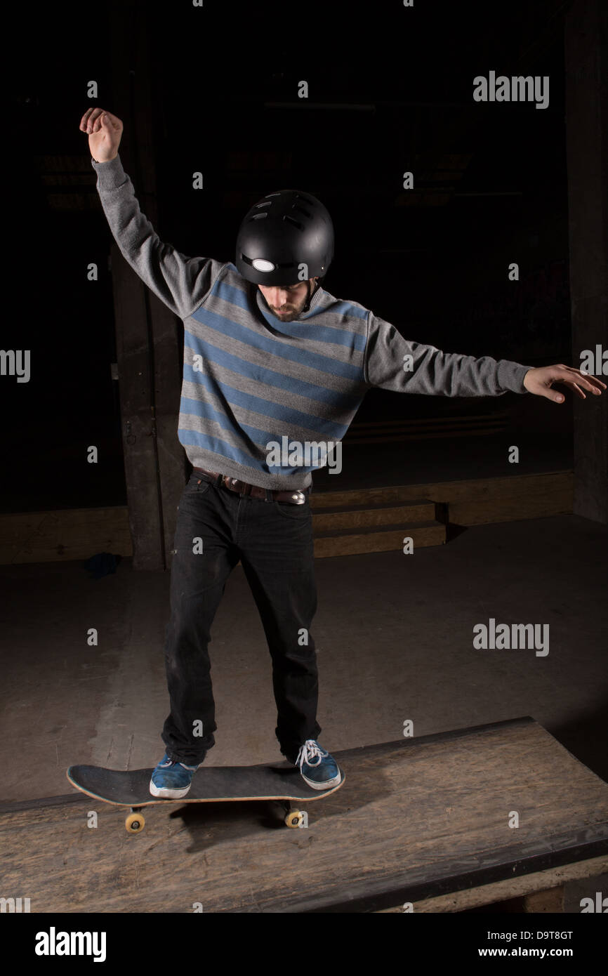 Skater doing manual trick on manual pad Stock Photo