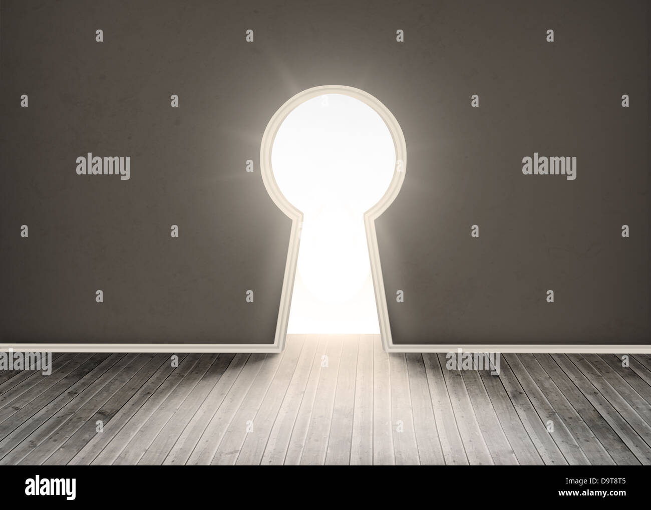 Door shaped keyhole showing bright light Stock Photo