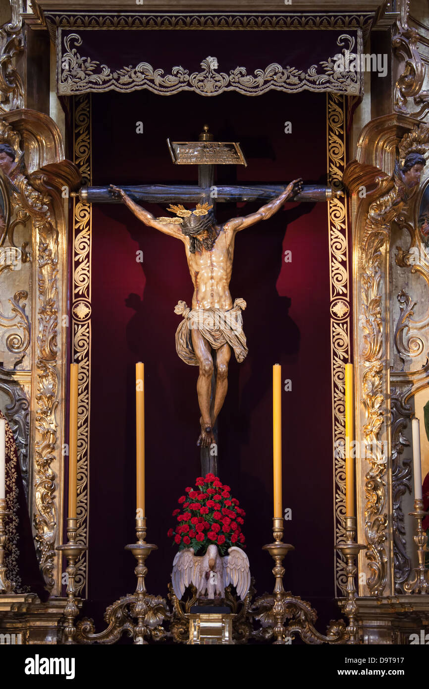 Jesus Christ on the Cross sculpture in the Church of the Divine Savior - Iglesia Colegial del Salvador in Seville, Spain. Altarpiece Christ of Love fr Stock Photo