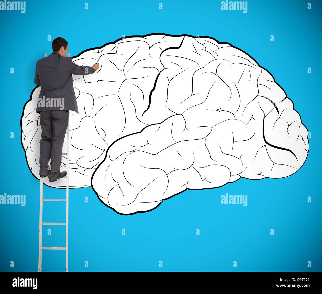 Businessman drawing a brain on a giant wall Stock Photo