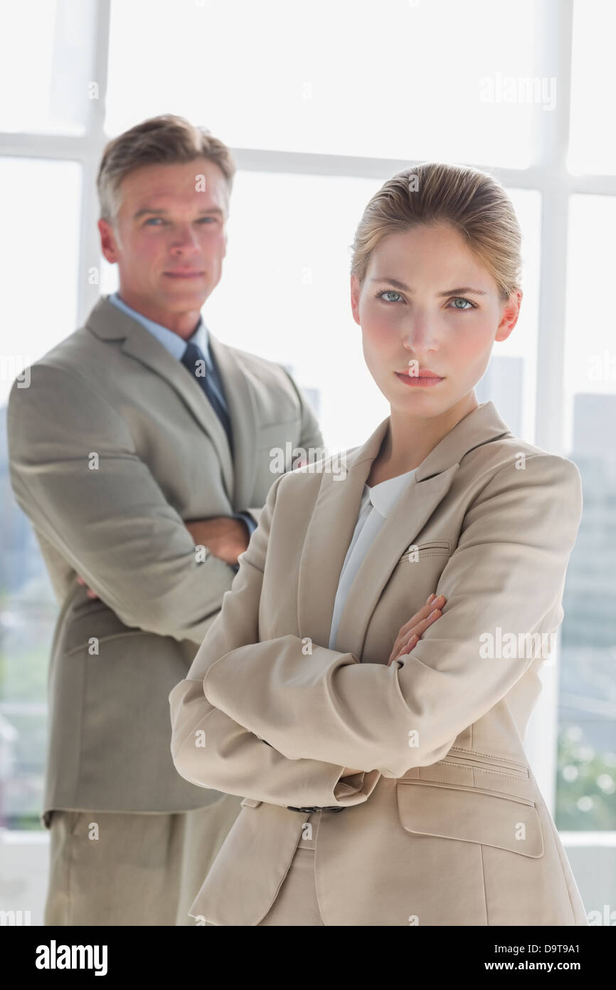 Serious business people standing with arms crossed Stock Photo - Alamy