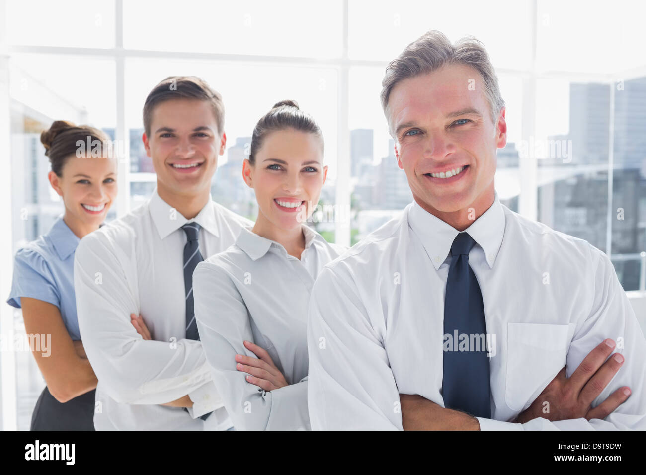 Smiling business people standing together in line Stock Photo - Alamy