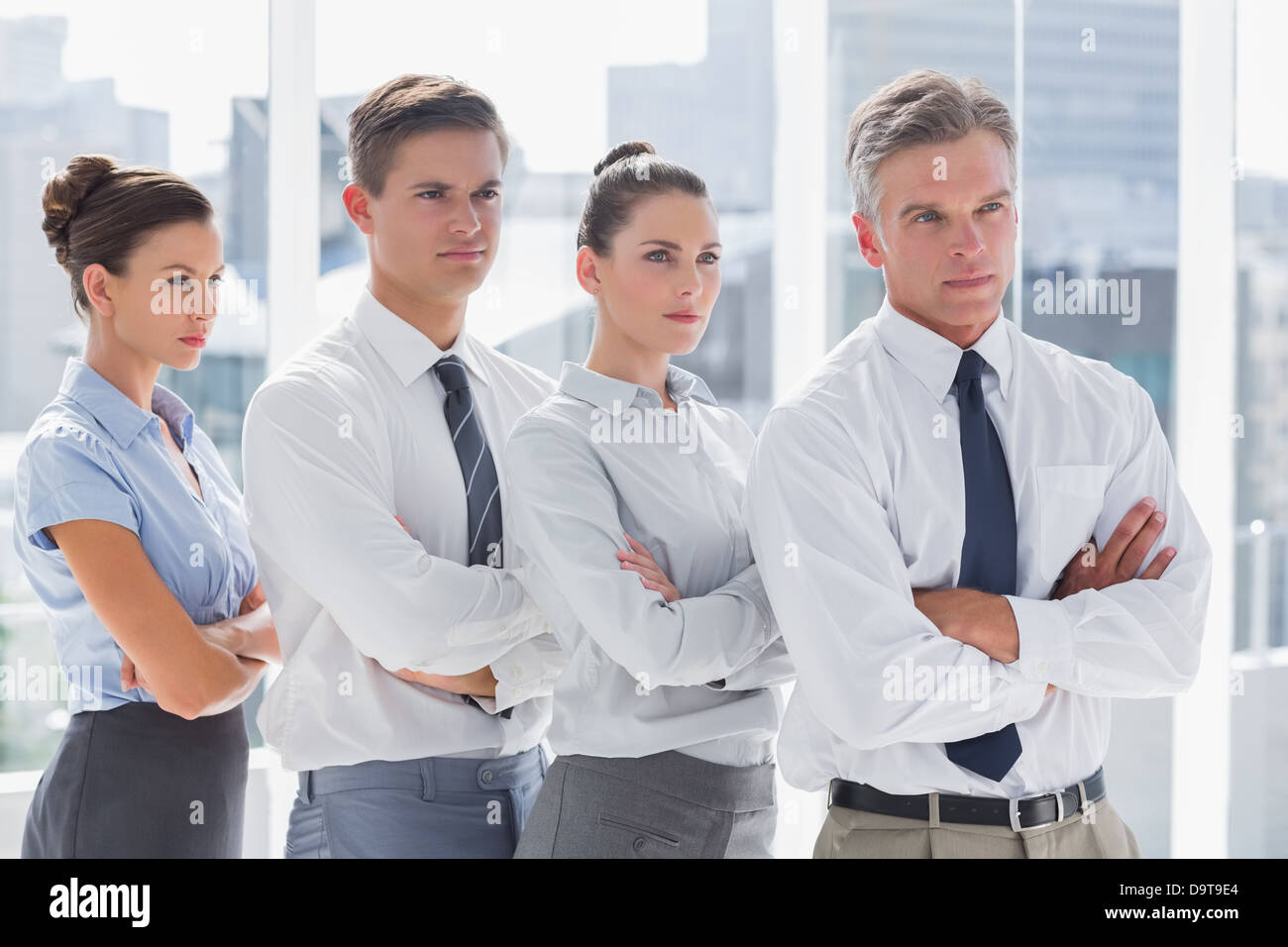 Serious business people standing together in line Stock Photo - Alamy