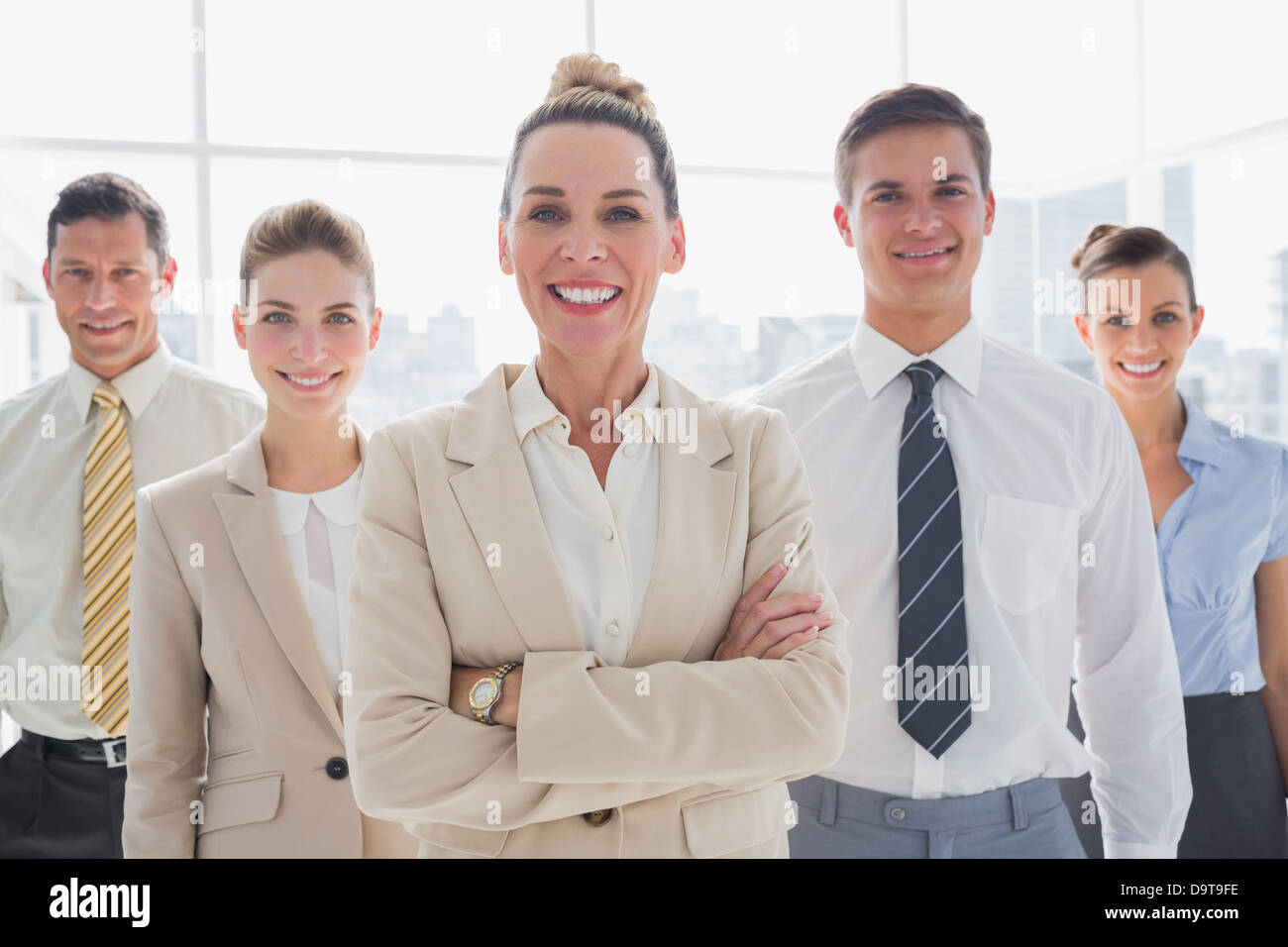 Group of smiling business team standing together Stock Photo - Alamy