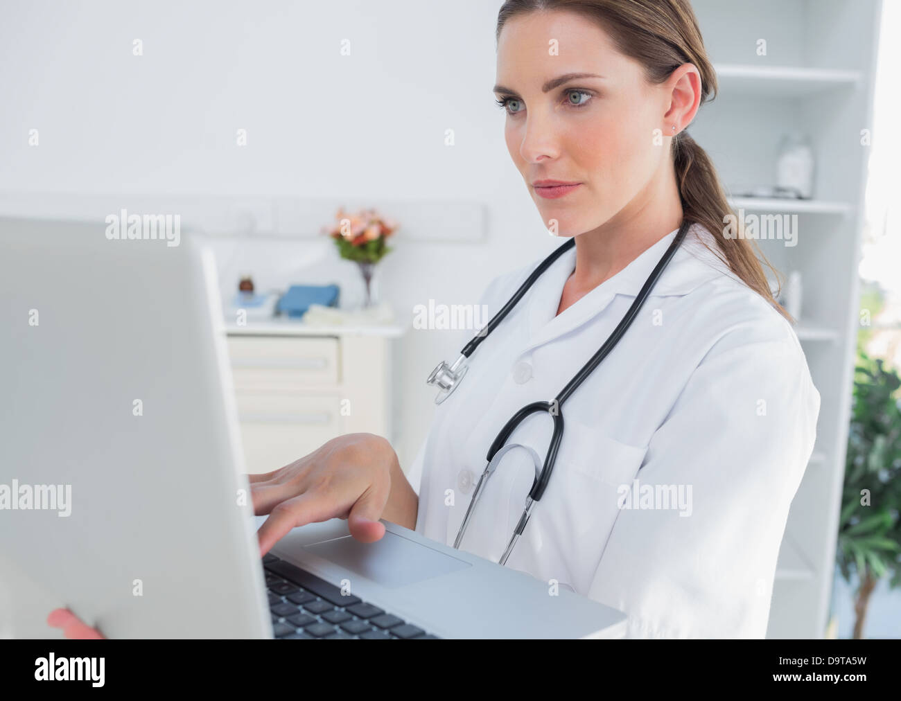 Doctor using stethoscope woman hi-res stock photography and images - Alamy