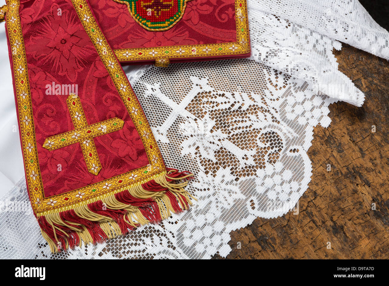19th century red damask chalice veil and maniple on a white lace catholic priest surplice Stock Photo