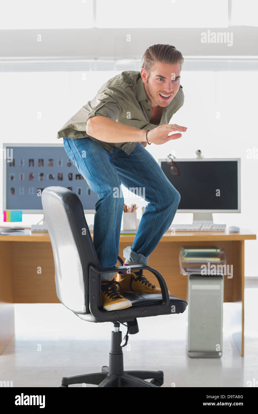 Handsome man surfing his office chair Stock Photo - Alamy