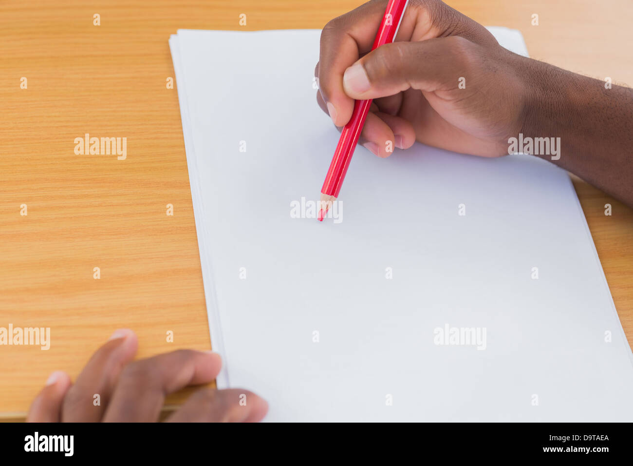 Man drawing with a red pencil Stock Photo