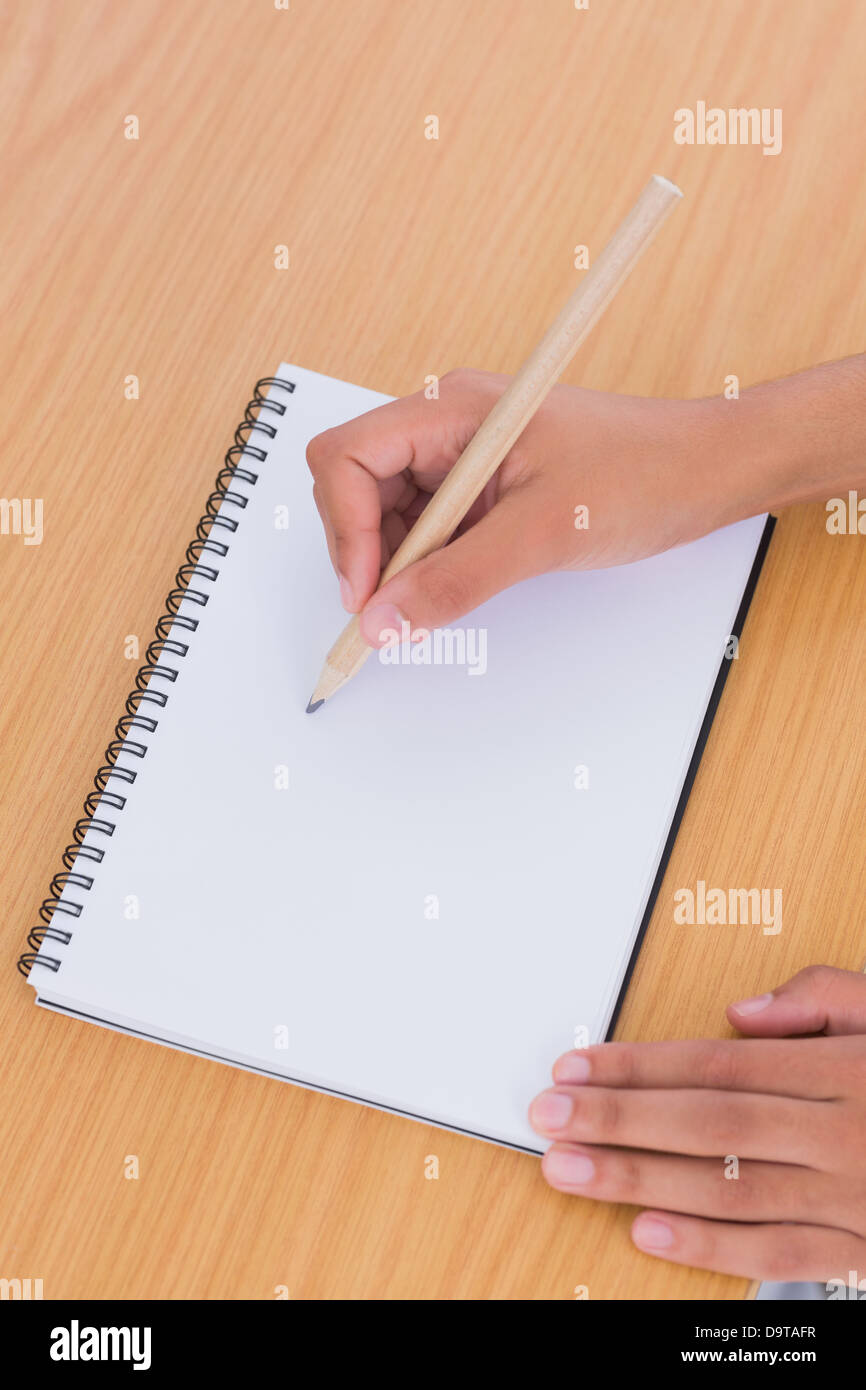 Woman drawing on a paper on a desk Stock Photo