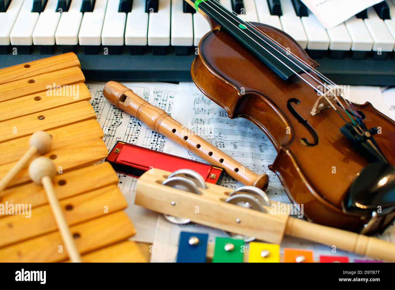 Musical instruments for children: xylophone, children's violin, tambourine, flute, harmonica, piano keyboard. Stock Photo