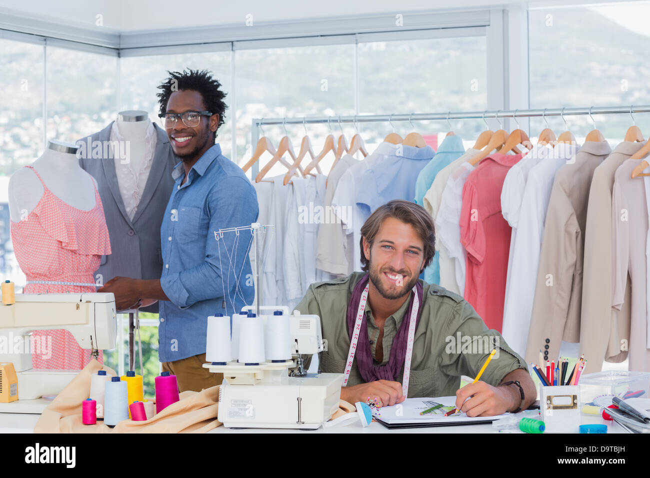 Fashion designers looking at camera Stock Photo - Alamy