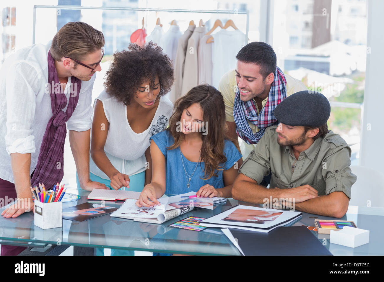 Young designers looking at photos Stock Photo - Alamy
